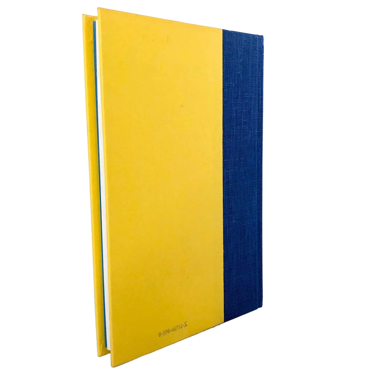 A hardcover notebook or journal standing upright on a light marble surface against a white wall. The cover is primarily bright yellow with a vertical navy blue textured panel on the right side.