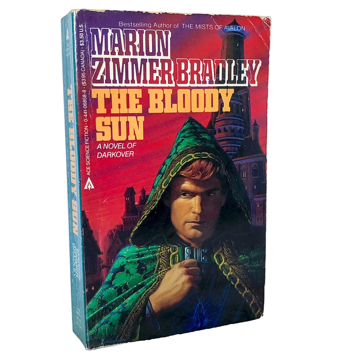 The Bloody Sun paperback novel by Marion Zimmer Bradley, showing the front cover and spine on a white background with a marble surface.