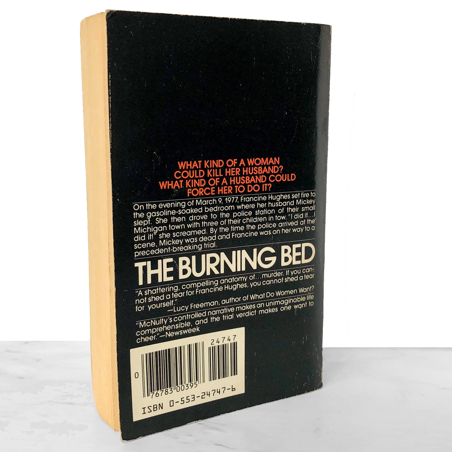 Back cover of a book titled 'The Burning Bed' with text and a barcode on a white background