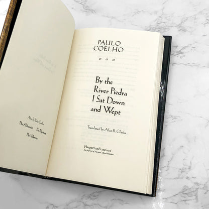 By the River Piedra I Sat Down and Wept by Paulo Coelho [U.S. FIRST EDITION] 1996 • Harper Collins