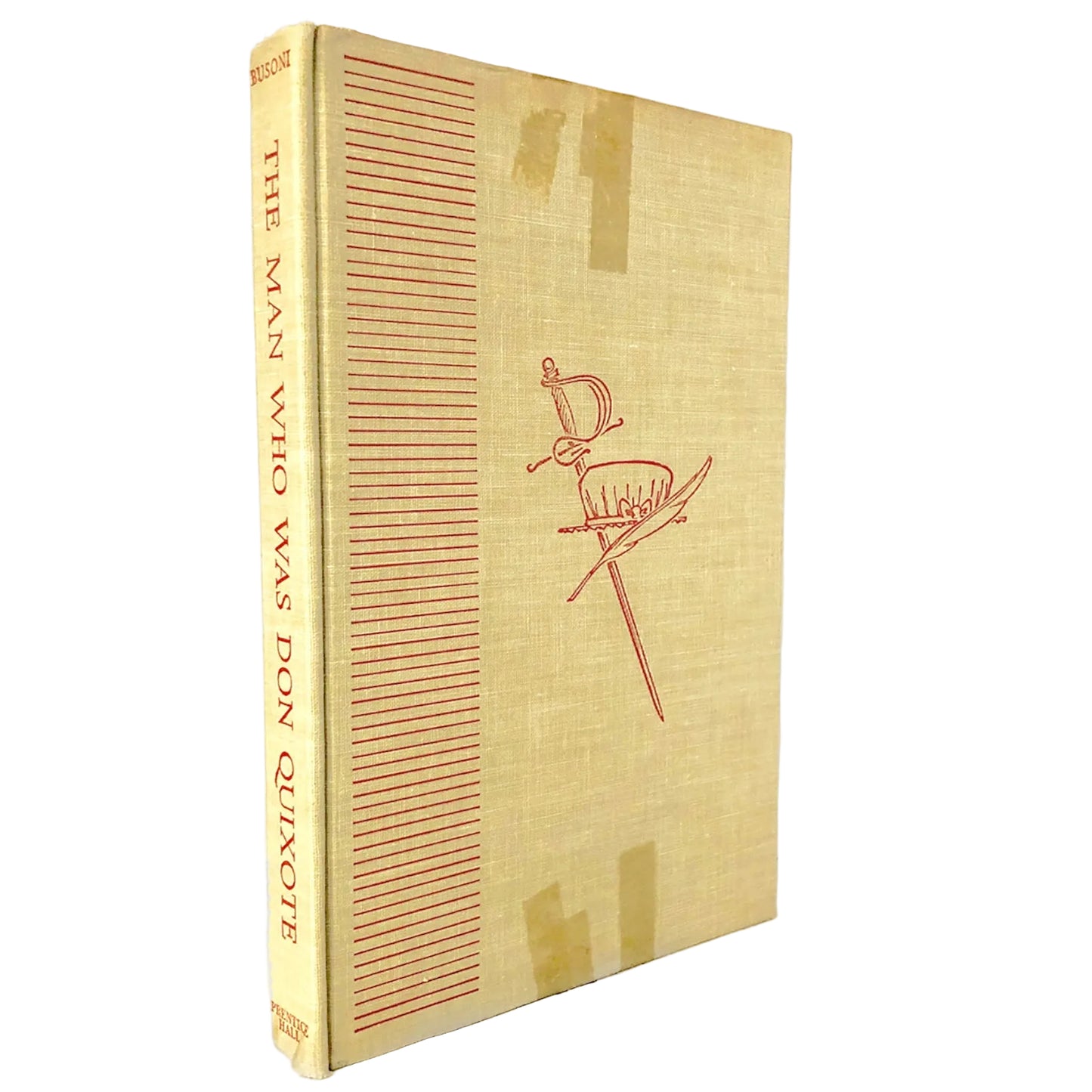 Vintage hardcover book titled 'The Man Who Was Don Quixote' with a tan linen cover and red line art of a sword, standing on a white background with a marble surface.