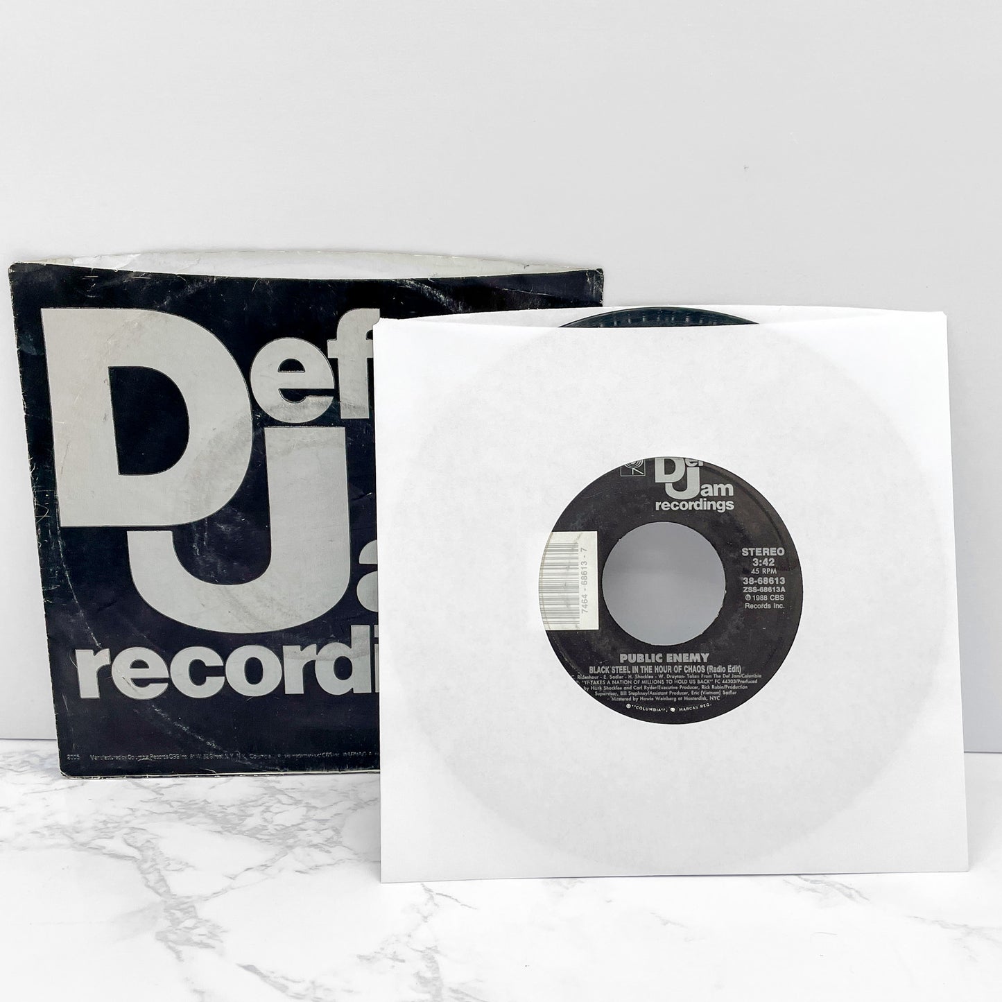 Public Enemy – Black Steel In The Hour Of Chaos b/w Caught Can I Get a Witness [7" VINYL SINGLE] 1988 • Def Jam