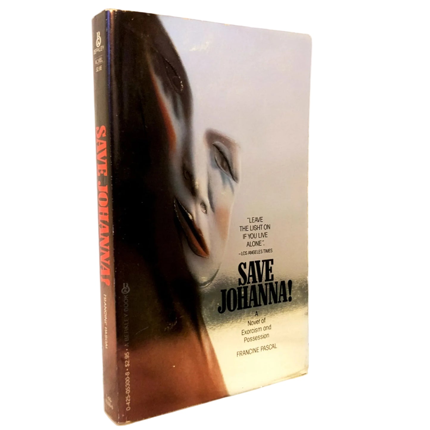 Vintage paperback book of Franchine Mastrotto's 'Save Johanna!' standing upright on a white marble surface against a white background.