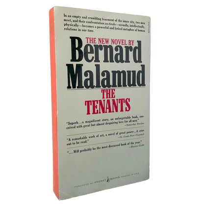 A paperback copy of the novel 'The Tenants' by Bernard Malamud, standing upright against a white background. The book features a light gray cover with black and red typography, and a distinctive orange-red spine.