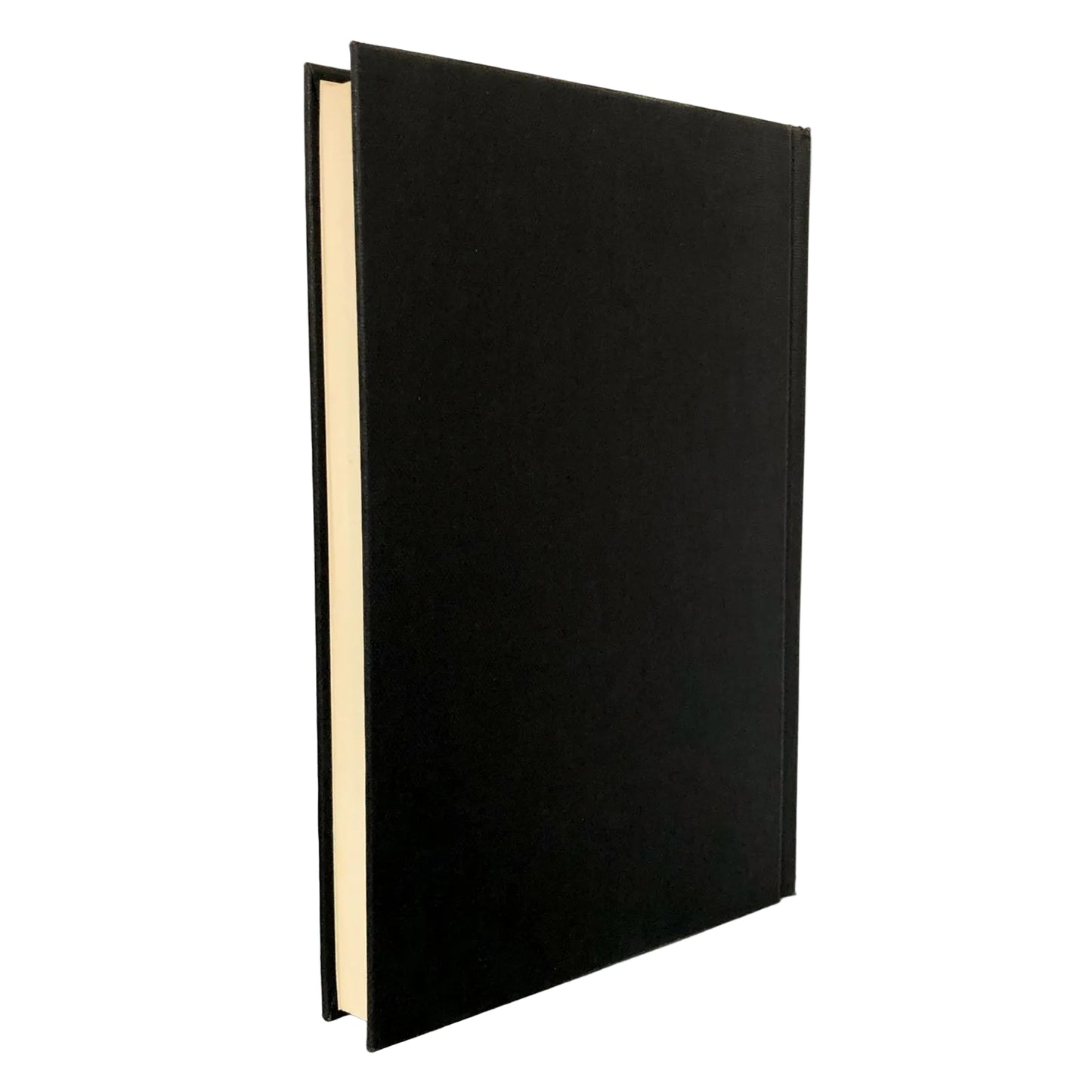A hardcover book with a matte black cover standing upright on a light gray marble surface against a white background.