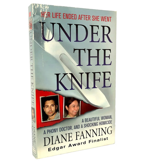 The book 'Under the Knife' by Diane Fanning, shown standing upright on a light marble-like surface against a white background. The cover features a large silver knife, dark purple title text, and red accents.