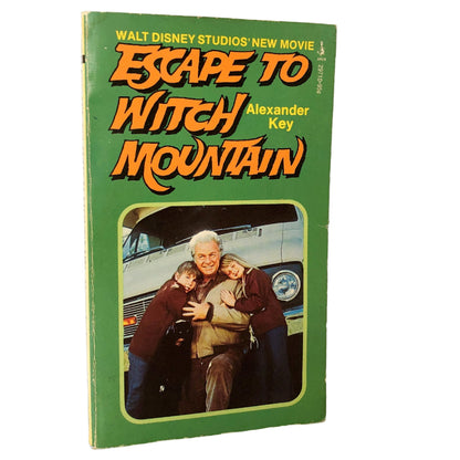 A vintage paperback book cover for 'Escape to Witch Mountain' by Alexander Key, featuring movie tie-in cover art with an image of the main characters.