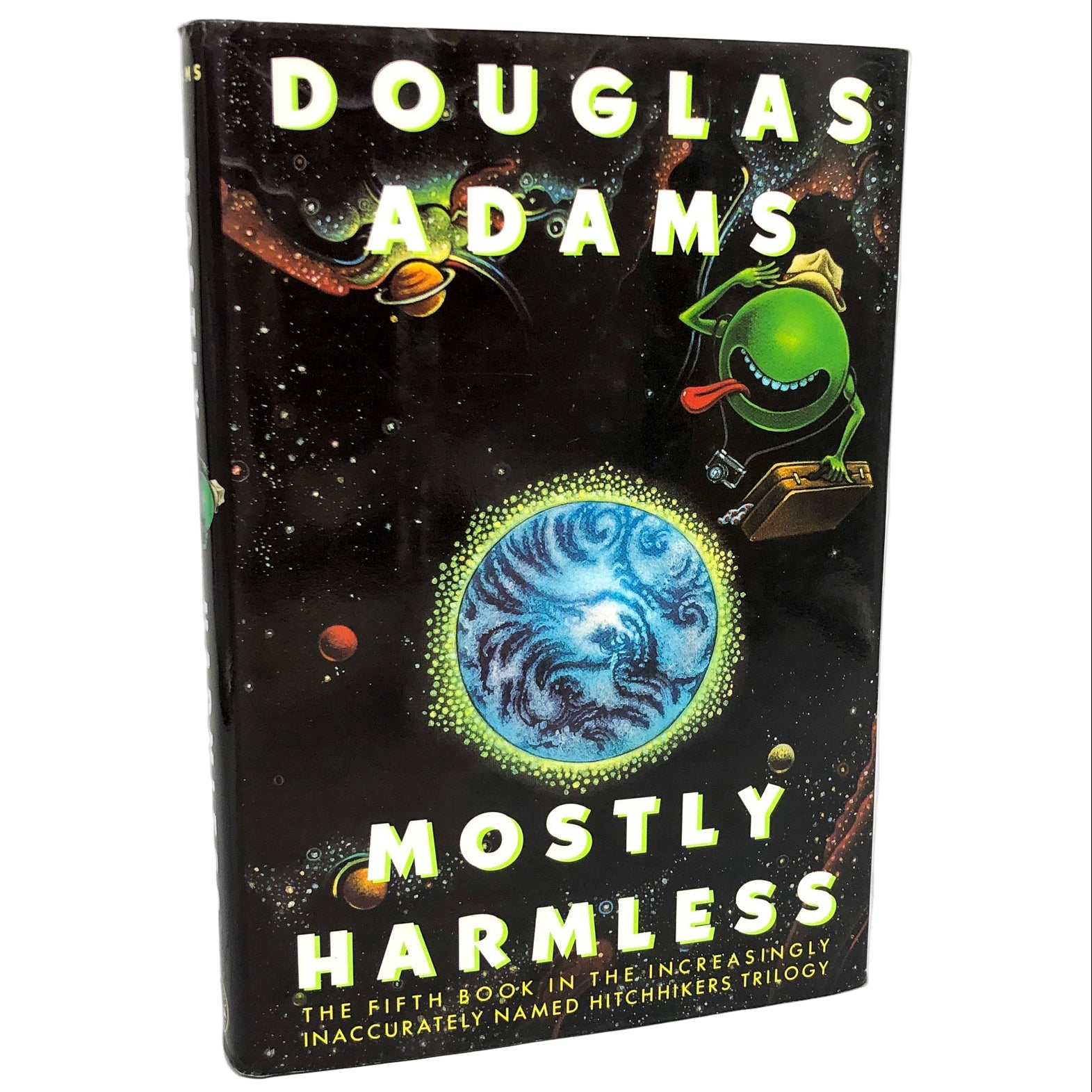 The cover of 'Mostly Harmless' by Douglas Adams features a black background with a colorful illustration of an alien character in a spacesuit, with a depiction of a planet and stars in the background. The book is labeled as the 'Hitchhiker's Guide to the Galaxy #5' and is described as a first edition, hardcover with dust jacket.