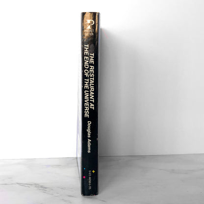 The Restaurant at the End of the Universe by Douglas Adams [FIRST PAPERBACK PRINTING / 1982]